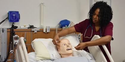 Nurse treating simulated patient